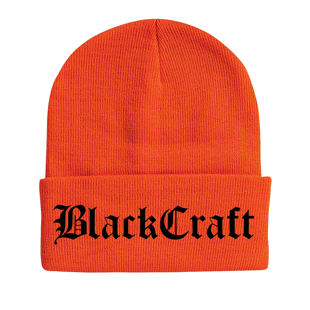 A bright orange classic knit beanie with Blackcraft logo across the front flap in Olde English font.