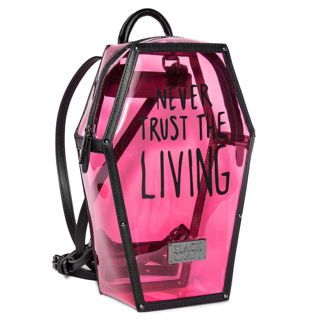 Clear pink PVC coffin shaped backpack with Never Trust the Living print on front. 