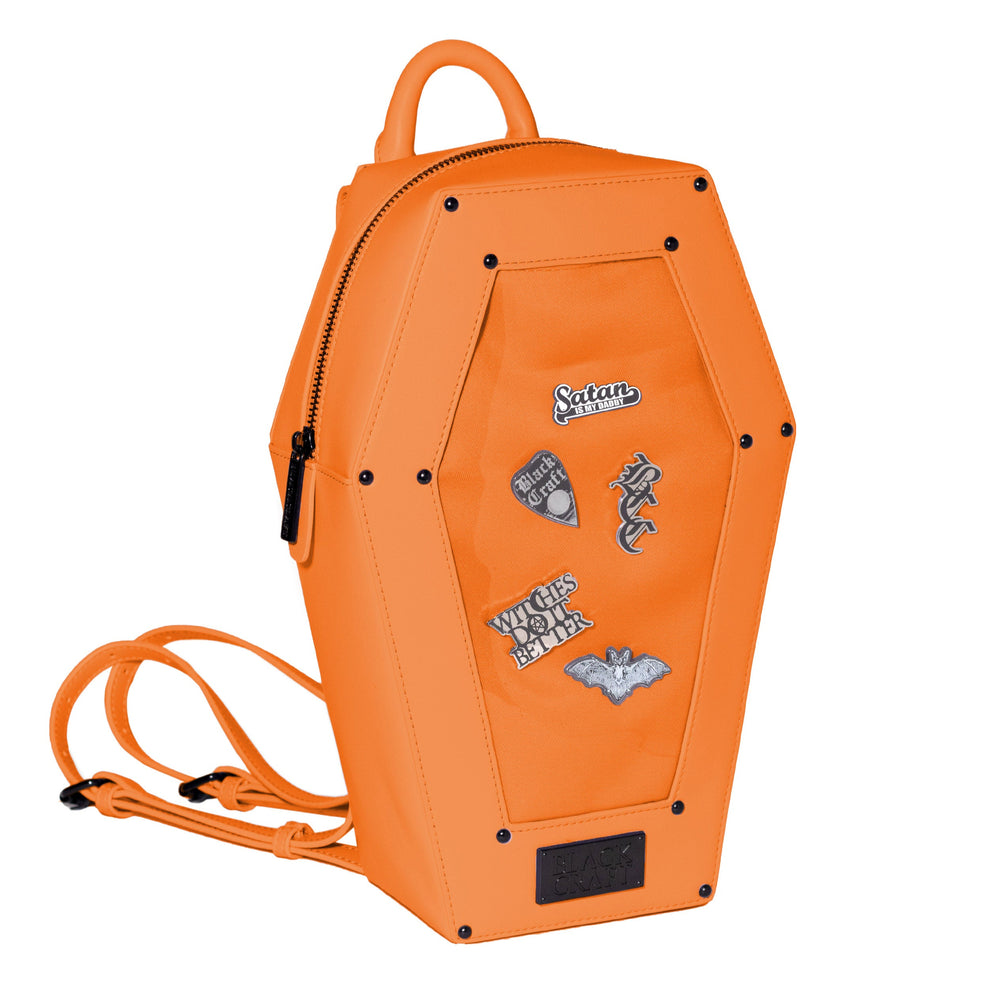 Orange faux leather coffin shaped backpack with a Pin Collecting Window. 