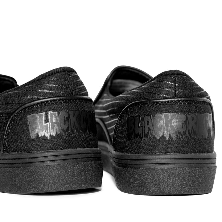 A slip on sneaker featuring our signature Ouija artwork on black canvas fabric upper and custom Blackcraft logo rubber sole.