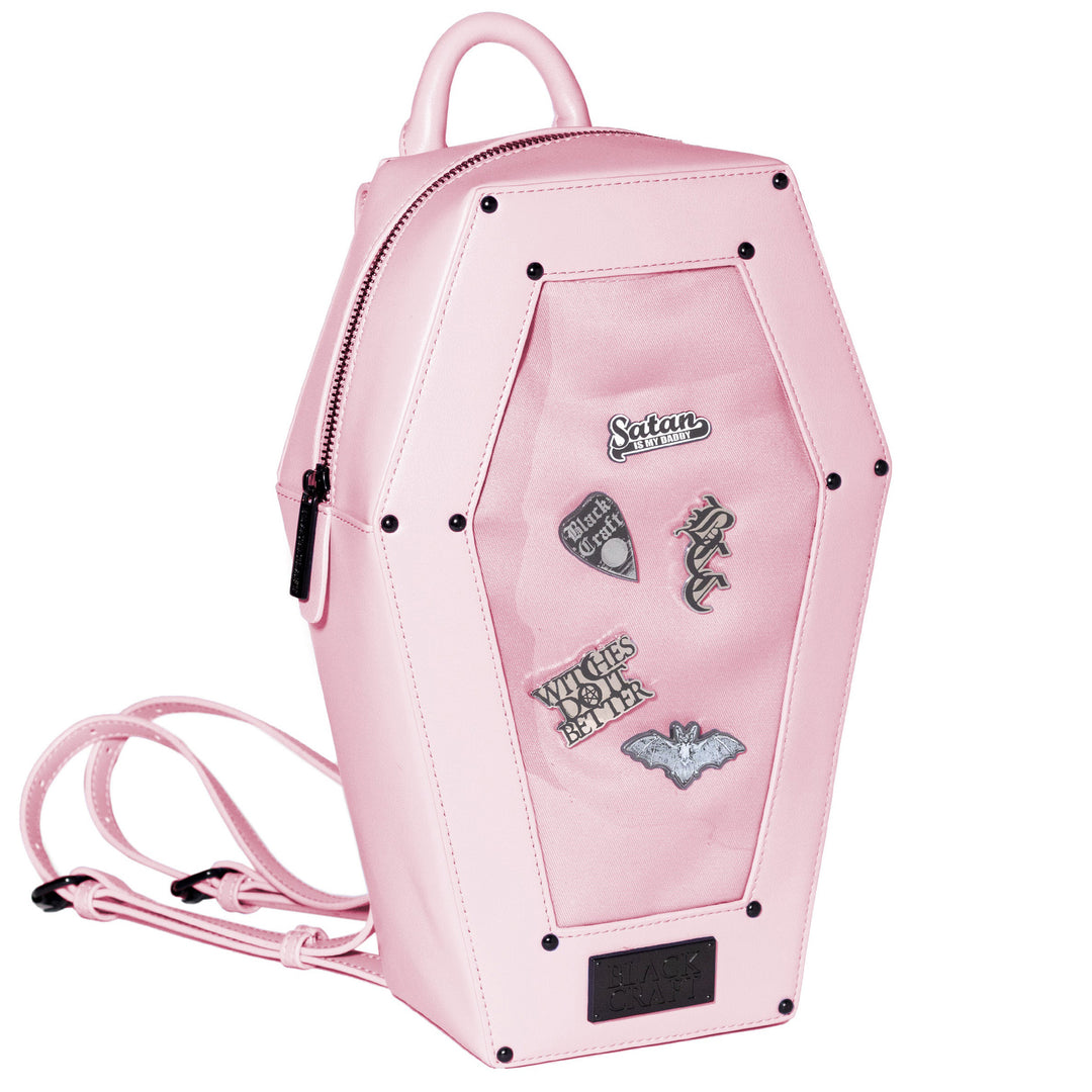 Pink faux leather coffin shaped backpack with a Pin Collecting Window. 