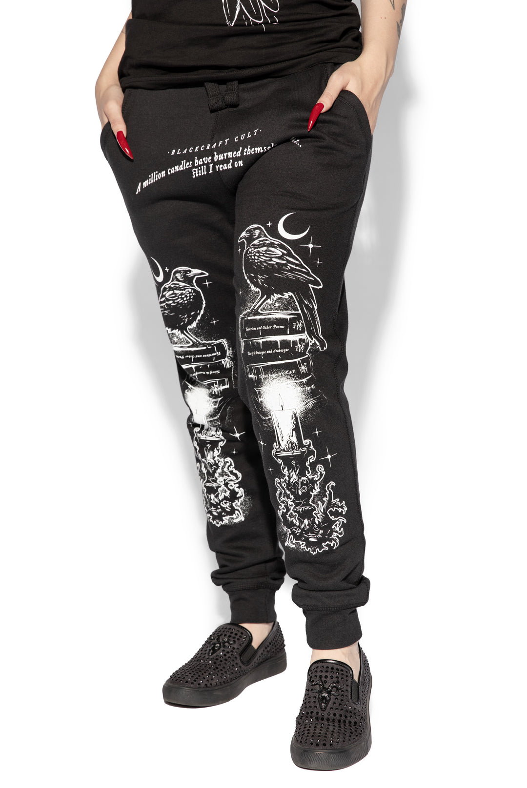 A model wearing a pair of classic fit black joggers with custom Blackcraft artwork along the front of each leg.