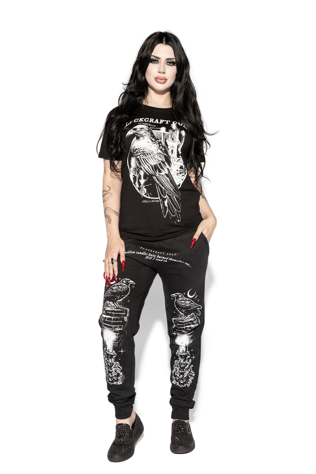 A model wearing a pair of classic fit black joggers with custom Blackcraft artwork along the front of each leg.