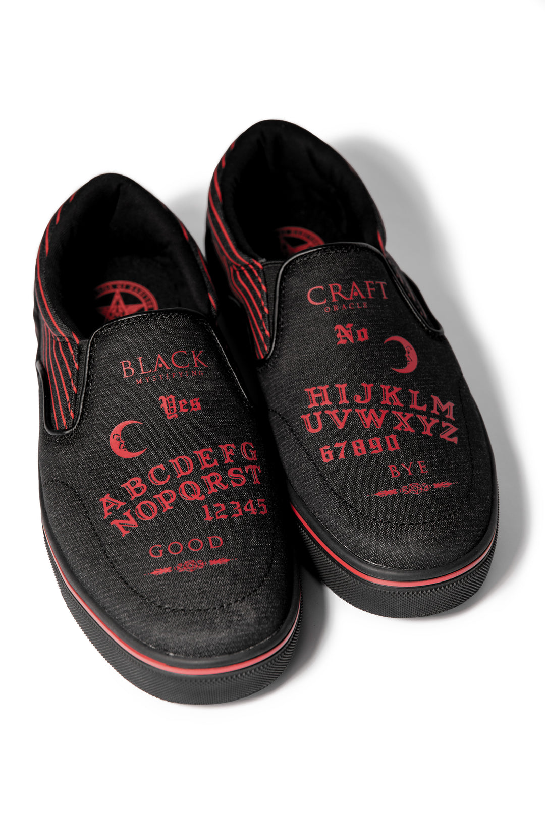 A slip on sneaker featuring our signature Ouija artwork on black canvas fabric upper and custom Blackcraft logo rubber sole.