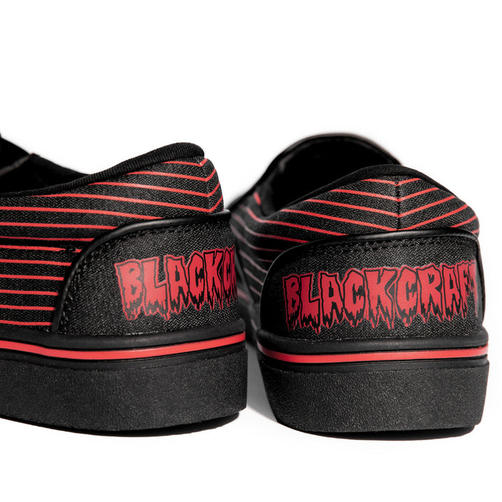 A slip on sneaker featuring our signature Ouija artwork on black canvas fabric upper and custom Blackcraft logo rubber sole.