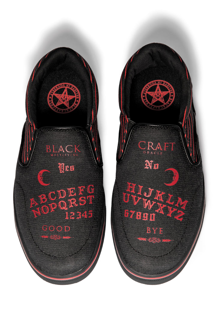 A slip on sneaker featuring our signature Ouija artwork on black canvas fabric upper and custom Blackcraft logo rubber sole.