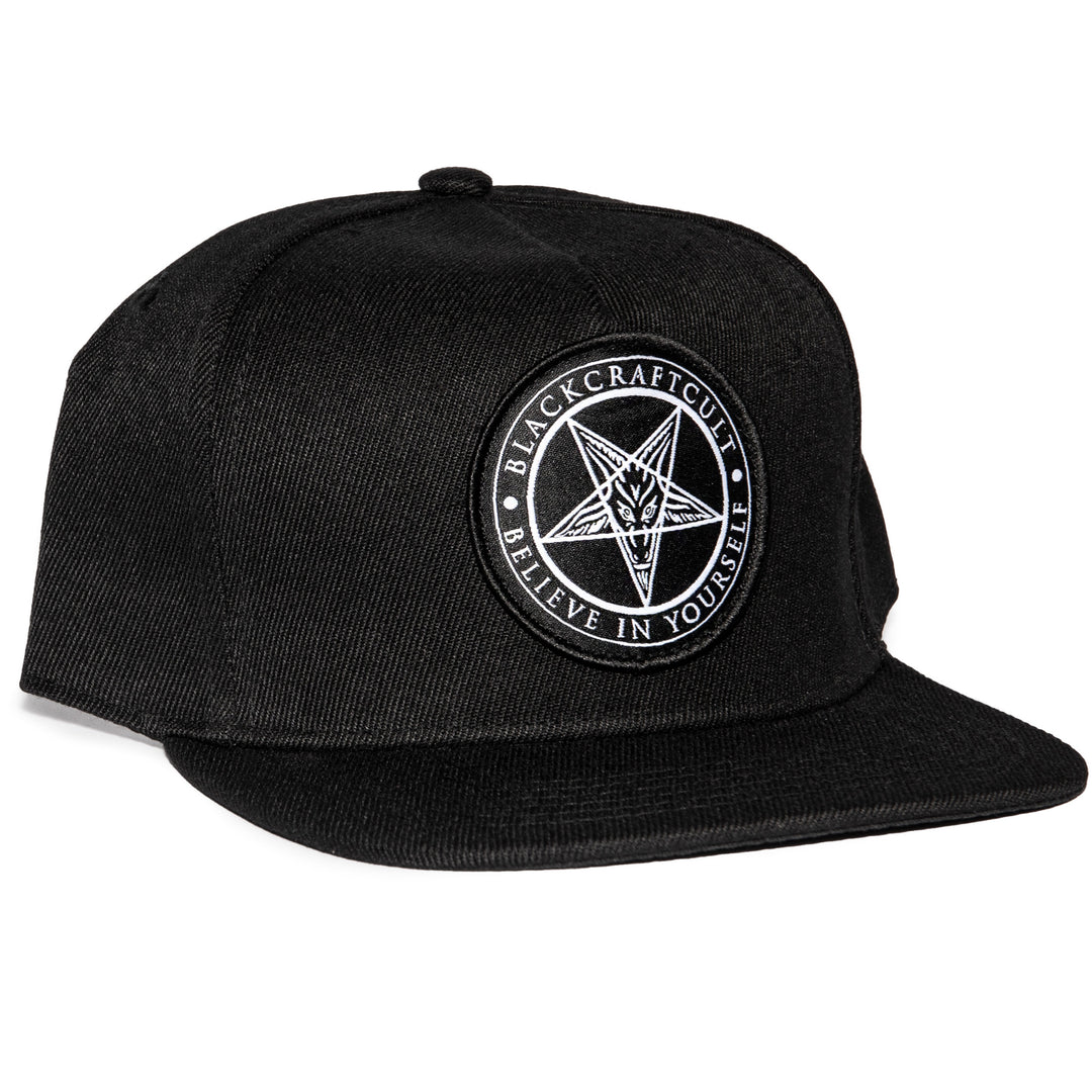 A classic black snapback hat with patch on the front.