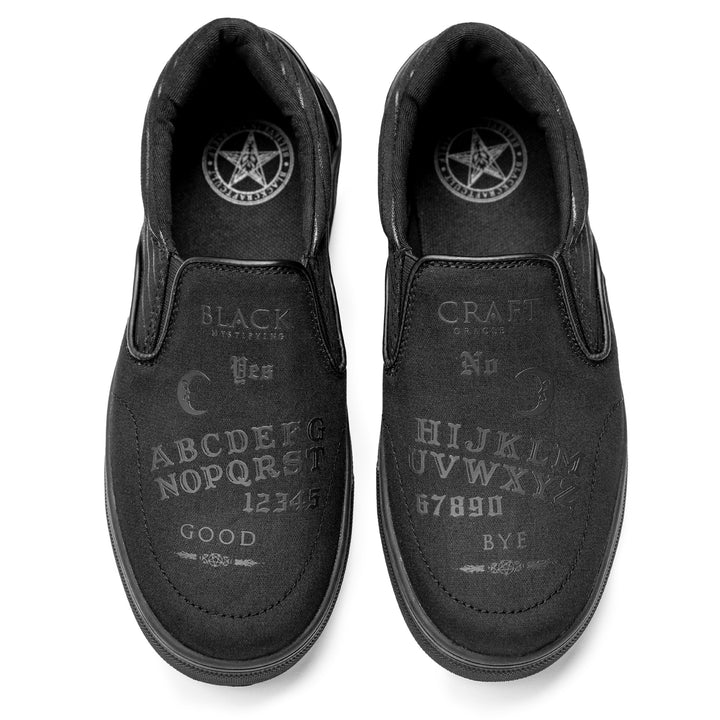 A slip on sneaker featuring our signature Ouija artwork on black canvas fabric upper and custom Blackcraft logo rubber sole.