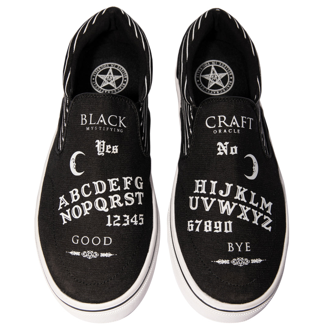 A slip on sneaker featuring our signature Ouija artwork on black canvas fabric upper and custom Blackcraft logo rubber sole.