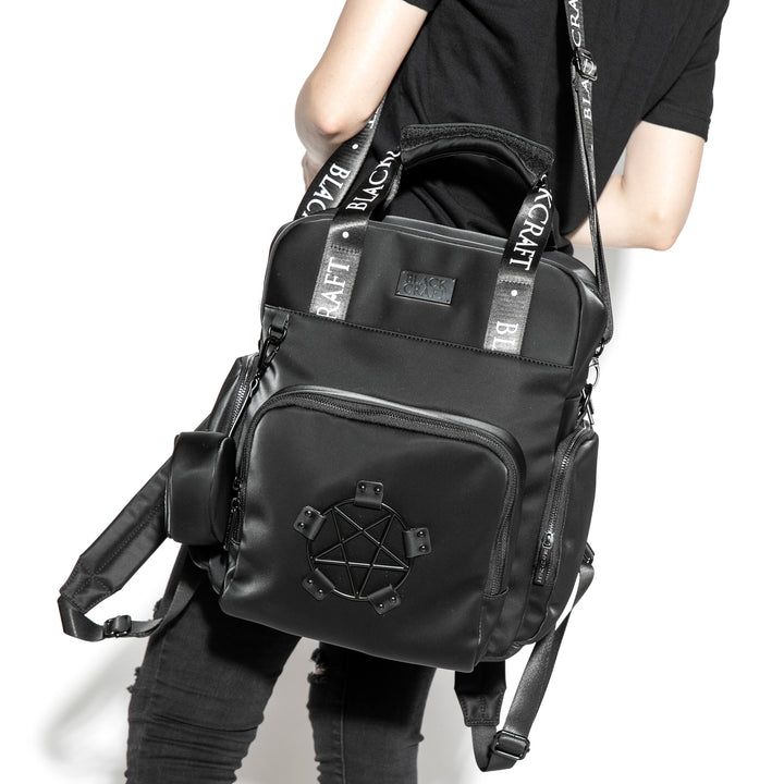 Black nylon diaper bag with top handle, removable and adjustable strap, and backpack straps for multiple options for wear.