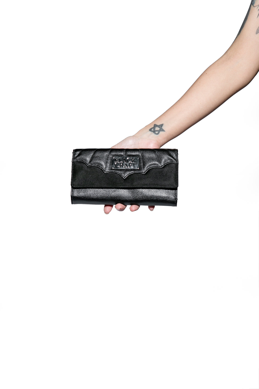 Black faux leather wallet that doubles as a clutch.