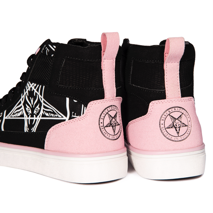 A pair of high top sneakers in pink and black. 