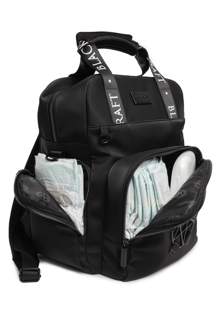 Black nylon diaper bag with top handle, removable and adjustable strap, and backpack straps for multiple options for wear.